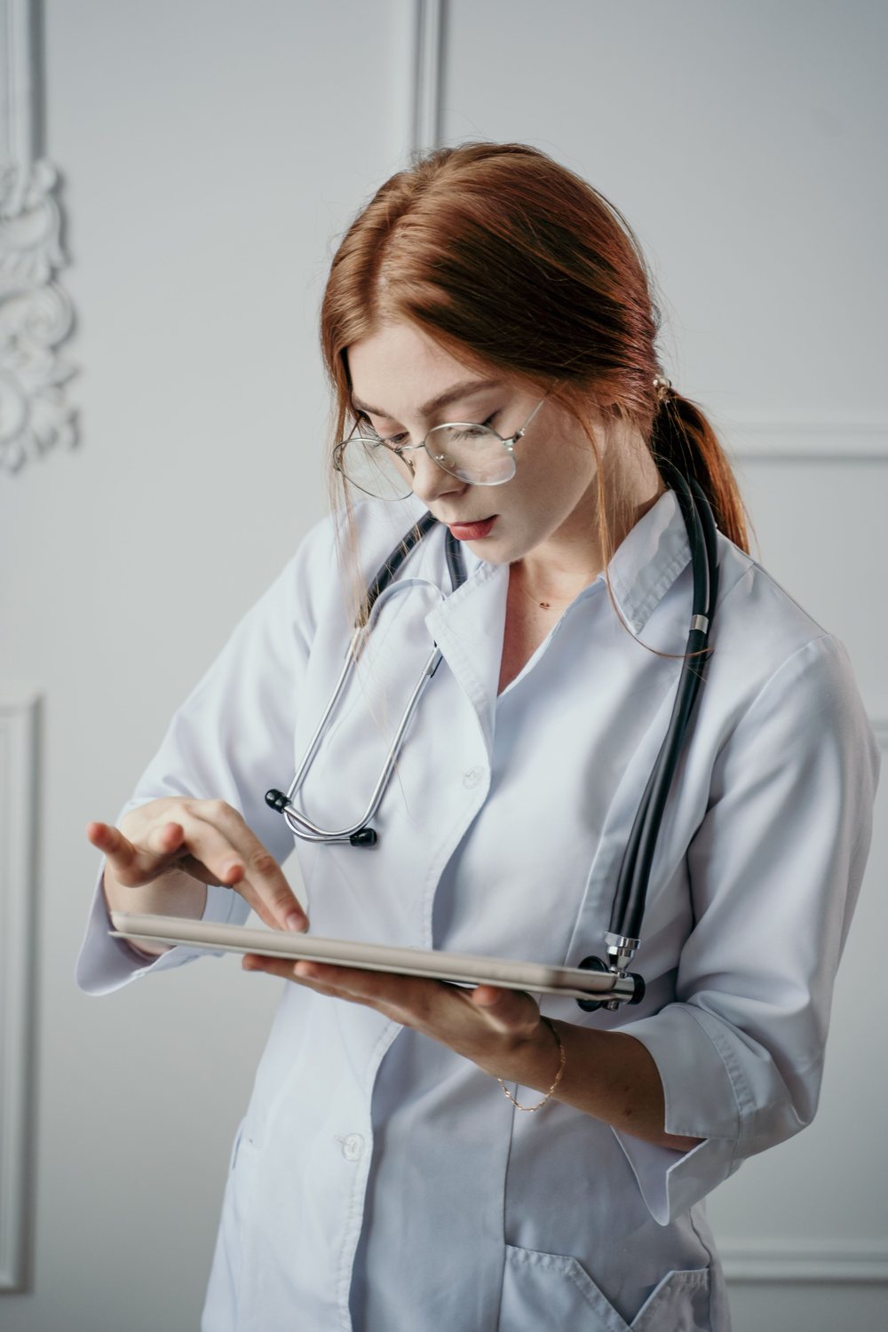 Healthcare professional reviewing information on a tablet